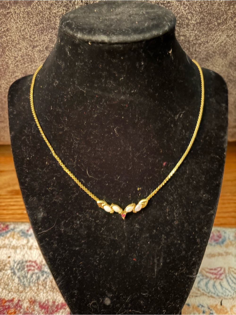 Gold Tone Leaf Pendant Necklace with White Enamel and Ruby Accent